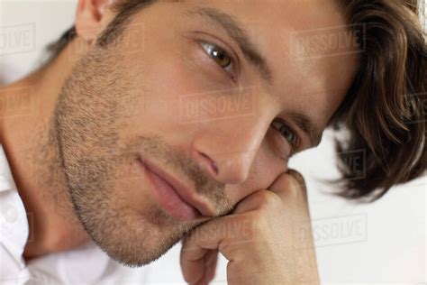 Man Resting Head On Hand Daydreaming Stock Photo Dissolve
