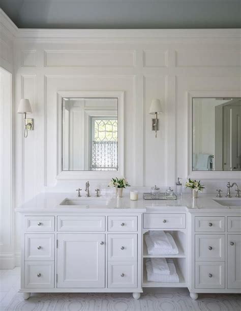 A White Bathroom With Double Sinks And Mirrors