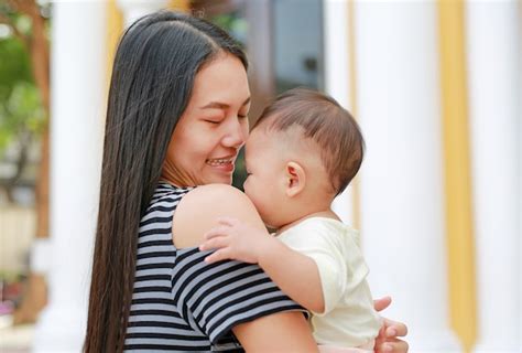 Premium Photo Asian Mother Carrying Her Infant Close Up