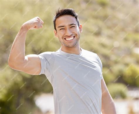 Premium Photo Fitness Nature And A Man Flexing Biceps With A Smile