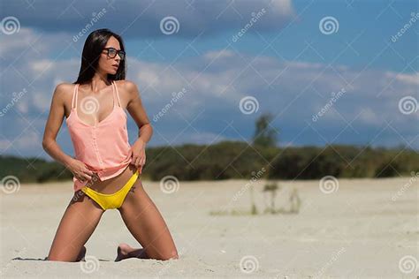sensual woman kneeling on beach stock image image of attractive woman 246064639