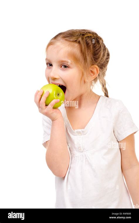 Little Girl Eating Apple Isolated On A White Background Stock Photo Alamy