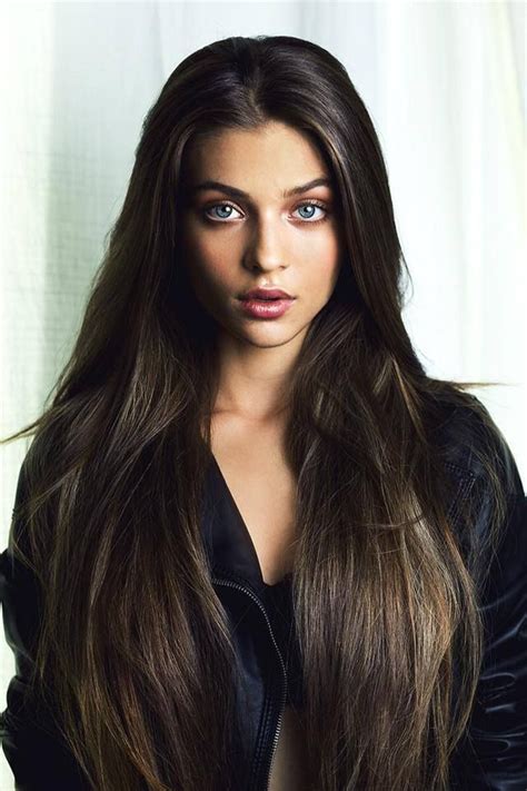 A Woman With Long Brown Hair And Blue Eyes