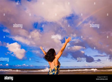 Rainbow Over Woman Raising Arms On Tunnels Beach At Sunset Island Of