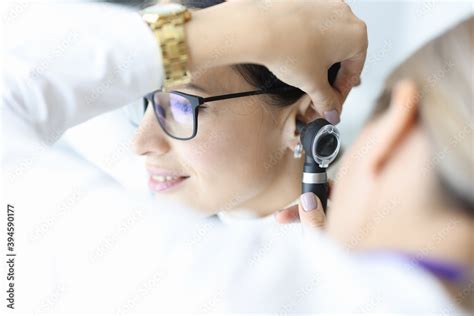 Otolaryngologist Doctor Examining Patients Ear With Otoscope In Clinic