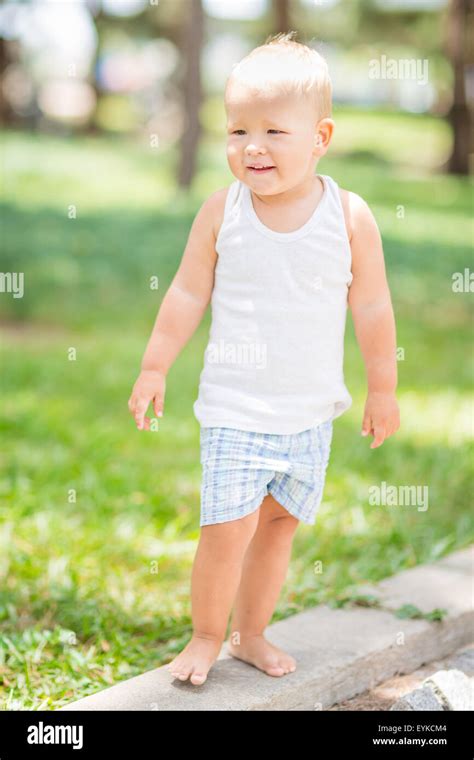 Baby Walking In The Park Stock Photo Alamy