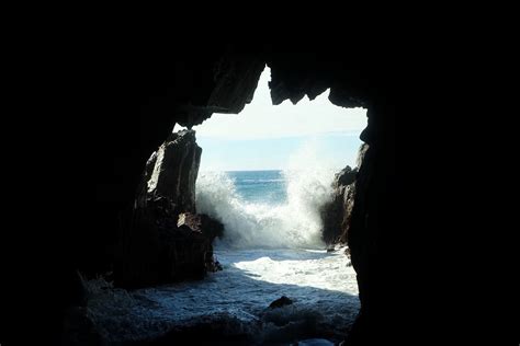 Sea Waves Splashing At The Entrance To A Dark Sea Cave Sea Cave