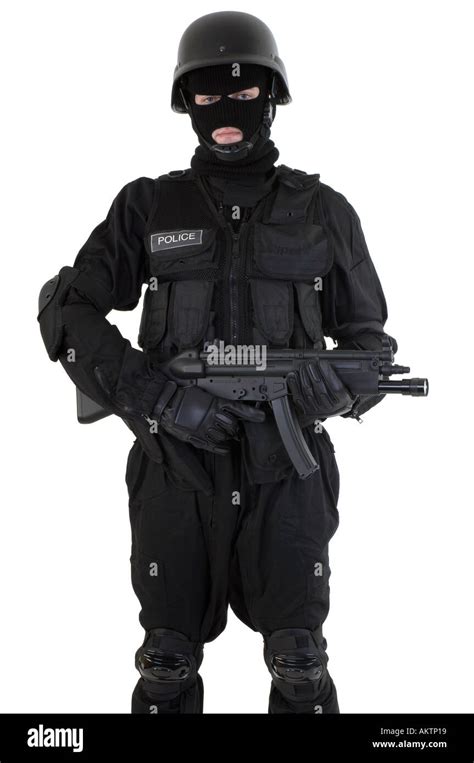 A Police Officer Dressed In A Swat Team Riot Uniform Holding And Firing
