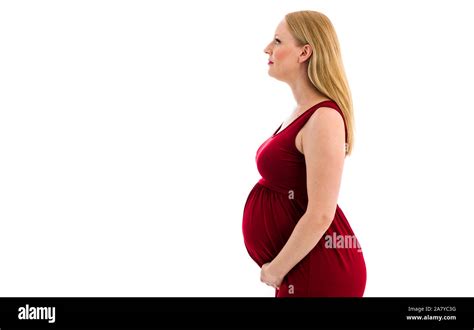 Pregnant Woman In Red Dress Holding Belly On White Background Portrait