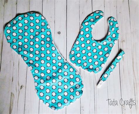 A Pair Of Oven Mitts Made Out Of Blue And White Polka Dots On Wood