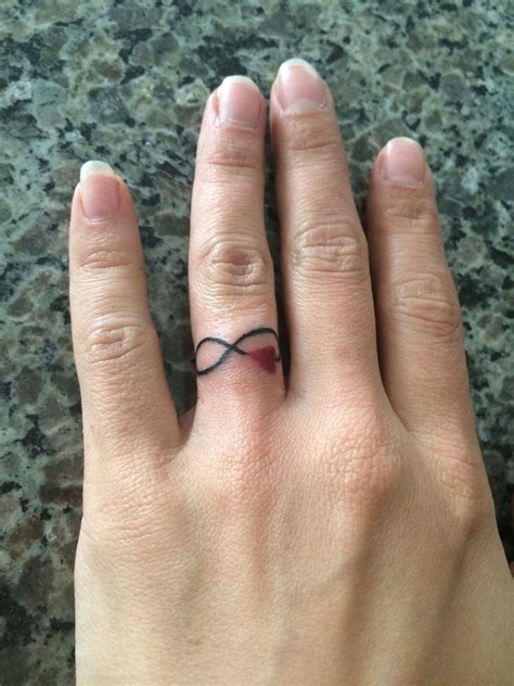 My New Tattoo Ring Finger Infinity Symbol And Red Heart