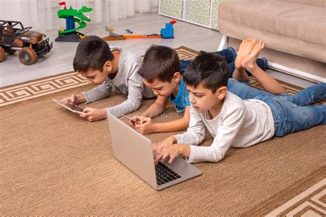 Children Of Different Ages Use Gadgets For Games Communication And For