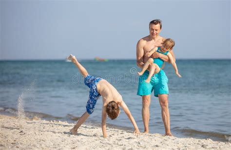 father his little daughter and son having fun on the beach stock image image of people play