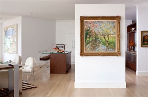 A Painting Hanging On The Wall Next To A Dining Room Table And Chairs