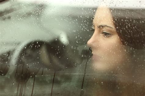 Sad Woman Looking Through A Car Window Beating Trauma