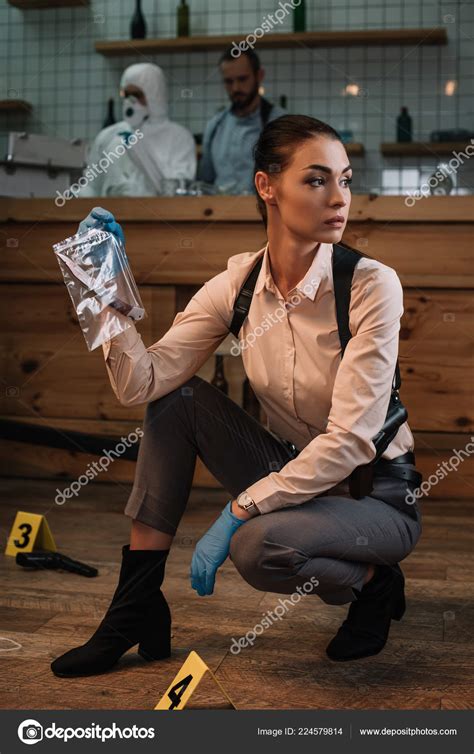 Female Detective Collecting Evidence Crime Scene Colleagues Working