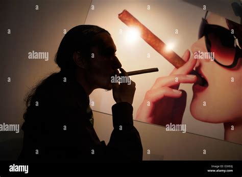Cigar Smoker In Front Of Poster Of A Woman Smoking A Cigar Photo By