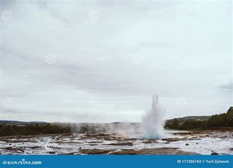 Famous Strokkur Fountain Geyser Hot Blue Water Eruption With Cloud Sky