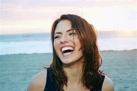 Portrait Of Laughing Caucasian Woman At Beach Stock Photo Dissolve