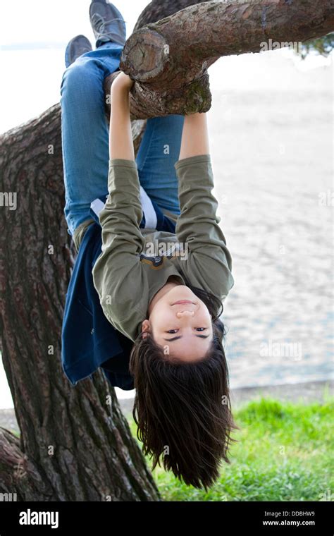 Young Girl Hanging Upside Down On Tree Limb Stock Play Girl Hanging