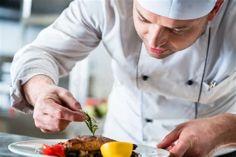 Chef Garnishing The Food On Plate To Complete The Dish Stock Image