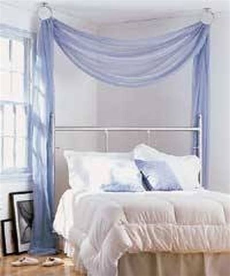 Next, drill a small hole in the spot over your bed where you want to hang your canopy to help guide the screws. How to Make a Hanging Bed Canopy | Hunker