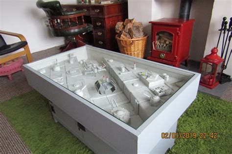 A 54″ long by 28″ wide diorama style coffee table featuring one of the most iconic ships in the star wars™ universe.this dynamic piece of furniture art features the millennium falcon™ navigating a dangerous asteroid field in an attempt to escape darth vader™ and the imperial fleet. Star Wars Coffee Table | RPF Costume and Prop Maker Community