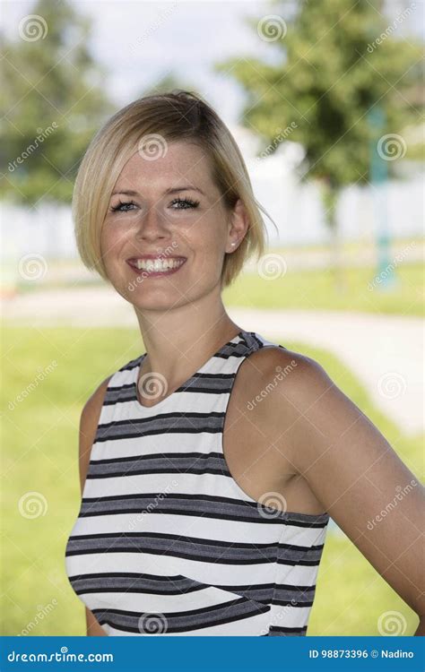 Close Up Of A Happy Blond Woman Smiling And Looking At The Camera