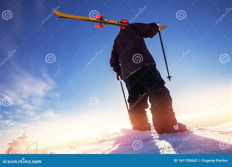 Skier Skiing Downhill During Sunny Day In Mountains And Forest Extreme