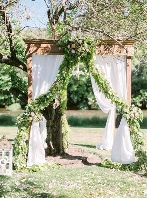 Gorgeous Wedding Arbor With Draped Fabric And A Chandelier Wedding