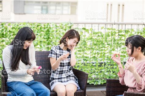 Japanese Girls Playing With Party Crackers At A Party In The Roof