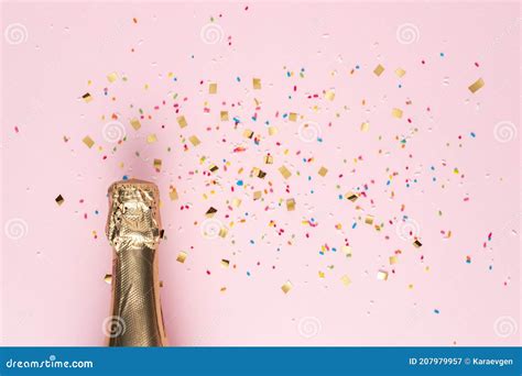 Golden Champagne Bottle With Confetti On Pink Background Minimal Party