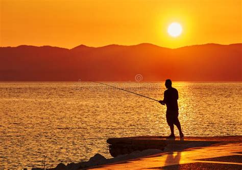 Fisherman Silhouette On The Beach At Sunset Stock Photo Image Of