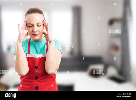 Housewife Housekeeper Or Maid Suffering A Painful Headache And Pressing