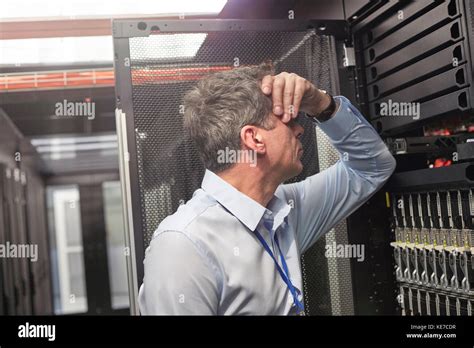 Frustrated It Technician At Panel In Server Room Stock Photo Alamy