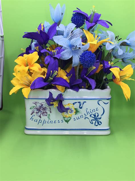 Use this display in an entryway or garden as both a storage space and as a gentle, lovely way to welcome in guests. Farmhouse Floral Centerpiece Gold Blue. Purple Floral ...