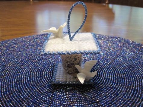 A Small T Box With Two Doves On It Sitting On A Blue Place Mat