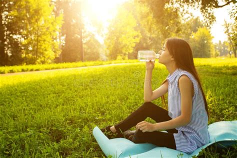 Teenager Health Girl Drinks Water After Sports On A Bench In The Park