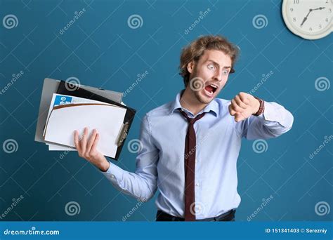 Stressed Businessman Trying To Meet Deadline On Color Background Stock