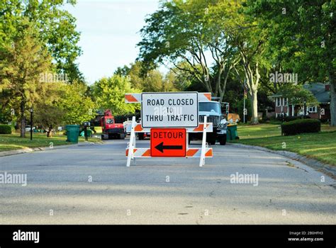 Road Closed To Thru Traffic Detour Construction Sign In A Residential