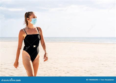 Pretty Woman With A Mask On Beach Corona Virus And Summer Vacation