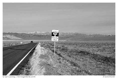 Black And White Picturephoto Sign Reading Loneliest Road In America