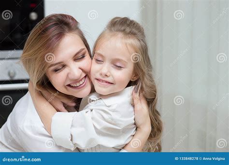 Happy Mother And Daughter Are Hugging At Home Stock Photo Image Of