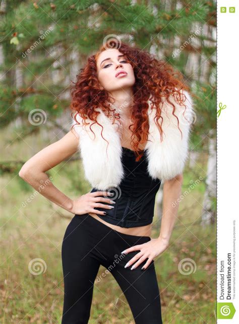 Woman In Corset With Fur And Curly Hair Poses In Forest Stock Image Image Of Beauty Cute