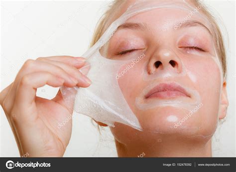 Woman Removing Facial Peel Off Mask Stock Photo By ©voyagerix 152478392