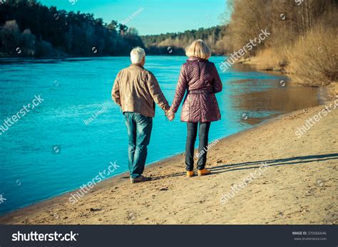 Elderly Couple Walking Hand Hand Along Stock Photo Edit Now 370066646