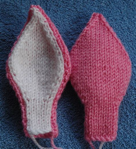Two french knots for the eyes, a bit for the nose, stitching down two ears and then attaching the head and tail to the body. Pin on knit