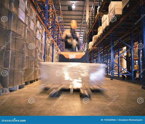 Worker Unloading Shipment Carton Boxes And Goods On Wooden Pallet By