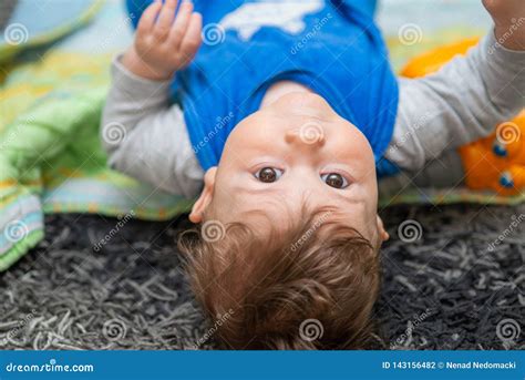 The Baby Boy Is Lying On The Back On Carpet Stock Photo Image Of Care