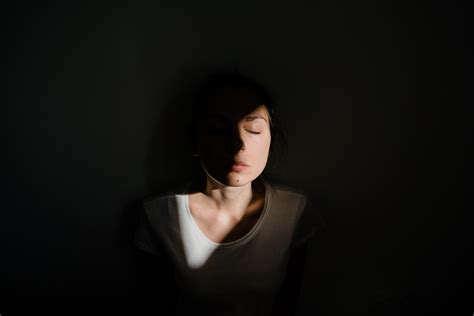 Girl Sitting Alone In Sunlight Pocket In Dark Room Mental Health